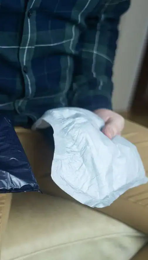 Image of man holding incontinence pads as part of overactive bladder treatment Reading