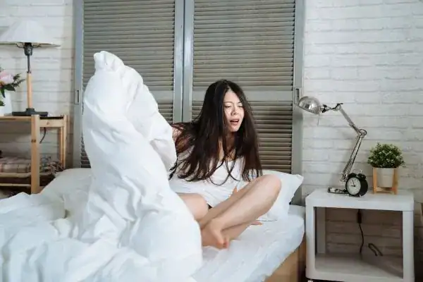 Image of woman getting up because of nighttime leaks Reading